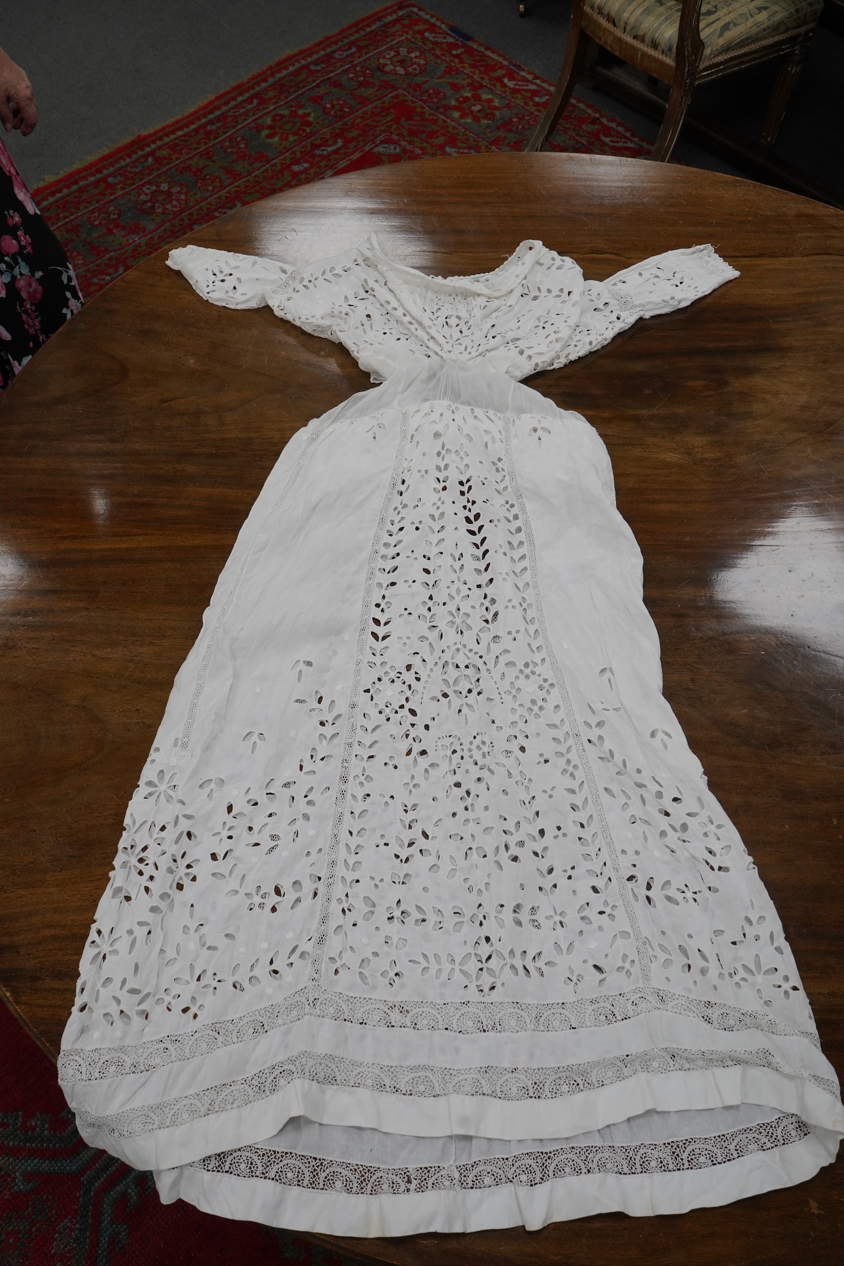 An Edwardian fine white embroidery anglaise and Irish crochet trimmed ladies summer dress, designed with large panels of anglaise cut work, the dress has been altered and restyled, which could be altered back, 134cm long